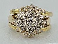 Front view of ring set showing floral halo diamond arrangement and matching band