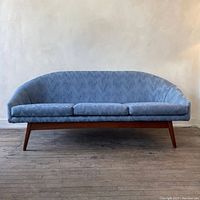 Full front view of sofa showing overall shape and cushion layout.