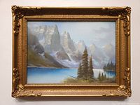 Frontal view of framed pastel painting showing mountain lake scene and ornate gold frame