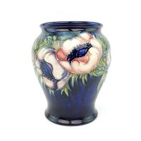 Front view showing vase with white and pink poppy flowers on cobalt blue ground