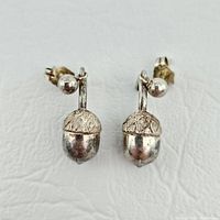 Front view of both acorn drop earrings hanging from ball studs