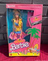 Full view of original pink packaging with Barbie doll displayed and graphics showing included cassette and comic book.