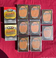 Two Magic Commander decks and ten stacks of sleeved cards in clear cases