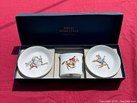 Set of Royal Worcester Equestrian Fox Hunt toothpick holder and two trinket dishes in box, showing front views of each piece with detailed horse and rider decorations.