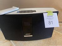 Speaker front view with remote on top