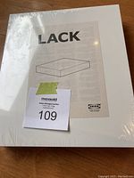Top view of the unopened IKEA LACK floating shelf box showing the mounting illustration and box label.