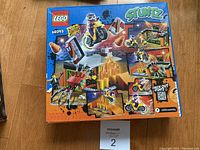 Photo of unopened LEGO Stuntz box with item number 60293 visible, showing stunt motorcycle scenes.