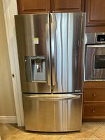 Front view of stainless steel French door refrigerator with bottom freezer drawer
