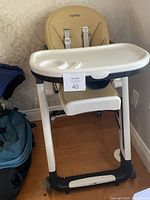 Full view of Peg Perego Siesta high chair with tray attached