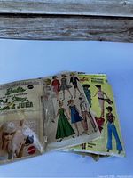 Packaging and illustrated fashion sheets for Barbie Stitch and Style from the 1960s