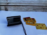 Kodak Disc 4100 camera with wrist strap placed on white surface against wooden background