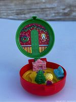 Open view of the vintage Polly Pocket compact playset showing the holiday-themed interior