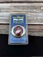 Front of the packaging showing the Marine Corps emblem in gear-like metal hood ornament