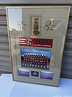 Full view of vintage 49ers framed collectible with team photo, patch and commemorative plaque.