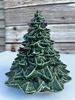 Front view of the ceramic Christmas tree showing detailed textured leaves and colorful bulbs fitted in.