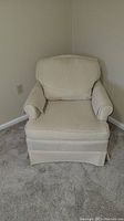 Front view of off white side chair with striped fabric upholstery and cushion on beige carpet.