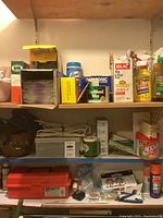 Photo of shelves with cleaning products and Sunbeam appliance box