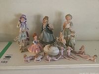 Photo showing entire assortment of figurines and the music box in a single view.