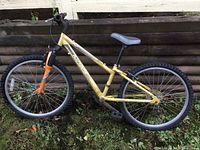 Side view of the yellow Norco Detonator bike showing entire frame, wheels, and front suspension fork.