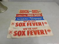 Four vintage 1960s Boston Red Sox bumper stickers displayed flat, showing text and logos from Atlantic gas, Narragansett beer, and Schaefer beer sponsors.