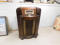 Full front view of vintage Philco wooden floor radio showing overall condition and style