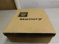 Original beige and black cardboard Mallory branded box for men's hat, showing some wear and aging