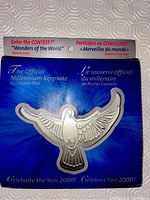 Front view of The Official Millennium Keepsake by Canada Post still attached to original blue backing card with contest details.