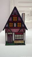 Front view of Tiffany Gallery Collection Xmas Lighthouse stained glass lamp showing design details.