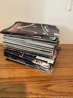Stack of International Gymnastics magazines with visible colorful covers showing gymnasts.