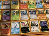 Display of 20 Pokemon cards in three rows featuring various characters and stats.