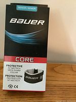 Front of box showing Bauer brand, Core series N7 neck guard collar for senior size, new in box.