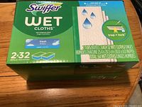 Front view of Swiffer Wet Cloths package showing brand, product name, scent and quantity details (2 tubs, 32 cloths each).