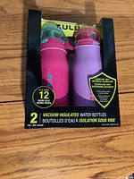 Front view of new Zulu boxed set containing pink and purple vacuum insulated water bottles.