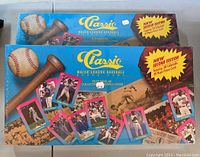 Photo showing two sealed 1989 Classic MLB board game boxes featuring blue packaging and vintage baseball imagery including a bat and glove.