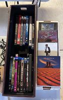 Photo showing a boxed set of DVDs with various titles visible including Santana, Led Zeppelin, and reissues of rock band concerts.