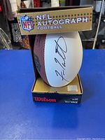 Mini NFL football in unopened gold and black NFL Autograph Football box showing Fran Tarkington's autograph.