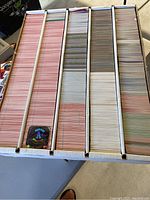 Top view of a large box filled with sports cards organized in rows.