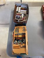 Wide shot of box with loose baseball cards stacked together, showing some individual cards and Topps Stadium Club packaging.