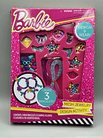 Front view of Barbie Jewelry Design Activity Set box showing charms and accessories arranged inside the packaging
