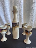 View showing the full set of the decanter and four goblets with the distinct dripping glaze