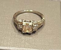 Front view of ring showing center and side diamonds