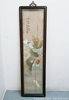 Full view of the framed silk textile showing overall composition