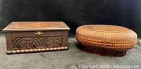 Side view of the wooden box showing carved dual lunette design and ball turnery base alongside the woven bamboo basket with detailed weave top and body.
