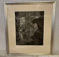 Framed black and white lithograph showing King Henry VIII, Anne Boleyn, and Cardinal Wolsey in an indoor historical setting.