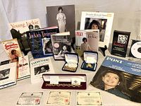 Full layout of collection showing jewelry boxes, books, VHS and DVD, arranged on table.