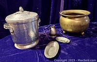 Photo showing the full lot: hammered aluminum ice bucket with lid and handles, footed brass planter, small pewter butter platters with tiny spoons, and a small pewter pitcher.