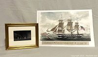 Photo of two marine-themed artworks together: small framed print on left, unframed print on right.