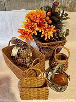 Overall collection showing the larger basket, smaller baskets, a bag of potpourri balls, and basket with fall flowers
