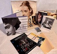 Photo of the full lot including books, screenplay, photo prints, poster collage, and cassette tape.