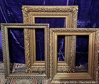 Three picture frames standing upright side by side showing styles and sizes